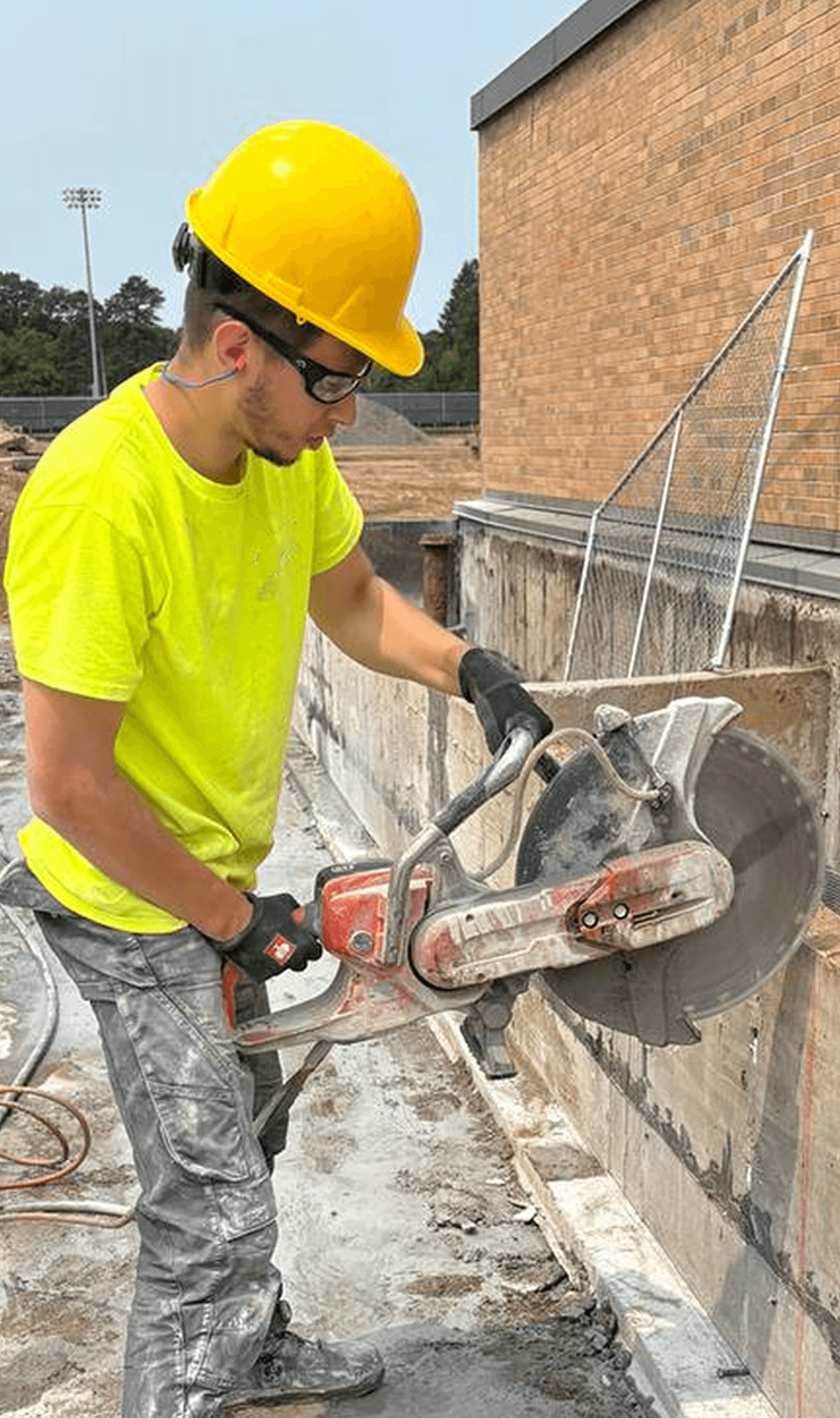 RedCore technician hand-sawing a concrete wall